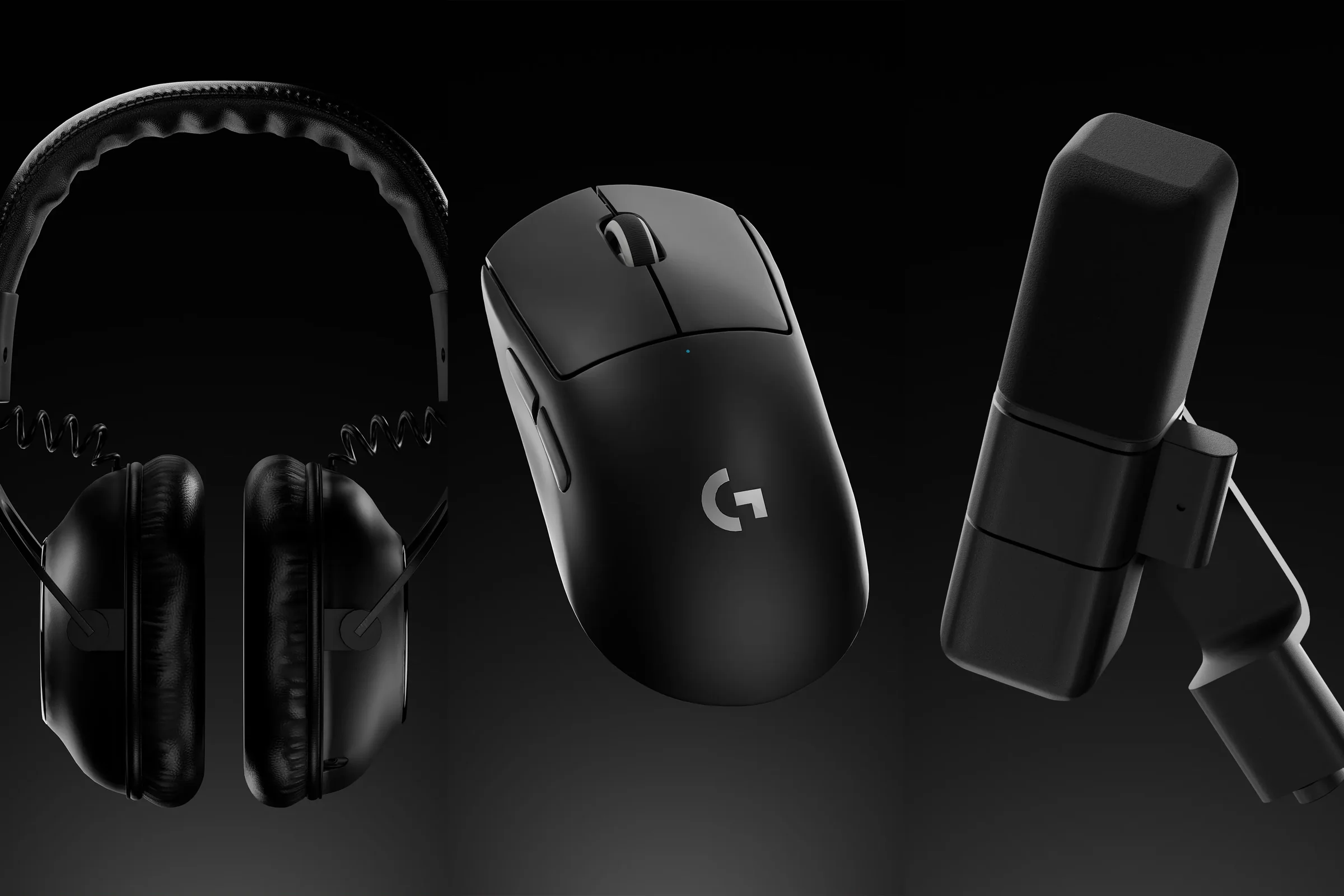 Gaming headset, mouse, and microphone arranged on a black studio background