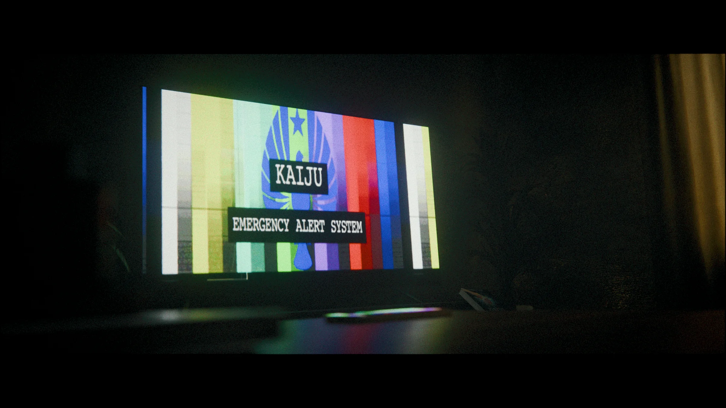 Kaiju emergency alert displayed on a television